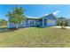 Picture of the front of the house with a lawn and white porch at 7360 David Blvd, Port Charlotte, FL 33981