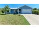 Charming single-story home featuring a well-maintained lawn, attached garage, and beautiful curb appeal at 7360 David Blvd, Port Charlotte, FL 33981