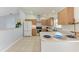 Bright kitchen features stainless steel appliances, wood cabinetry, and a neutral tile floor at 7360 David Blvd, Port Charlotte, FL 33981