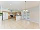 Well-lit kitchen with stainless appliances, wood cabinets, and access to the outdoor space at 7360 David Blvd, Port Charlotte, FL 33981