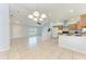 Open floor plan with tile flooring, view of the kitchen, and lots of natural light at 7360 David Blvd, Port Charlotte, FL 33981