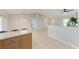 Spacious living area featuring neutral paint, tile floors and half wall at 7360 David Blvd, Port Charlotte, FL 33981