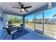 A screened patio with a ceiling fan and an outdoor seating area at 7360 David Blvd, Port Charlotte, FL 33981
