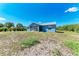 Rear exterior of this quaint home featuring a screened in porch at 7360 David Blvd, Port Charlotte, FL 33981