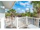 Backyard stairway, with white rails, overlooking palm trees and water at 7536 Palm Island S Dr # 1522, Placida, FL 33946
