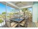 Enjoy the screened balcony with a dining table set and scenic views of the beach and ocean at 7536 Palm Island S Dr # 1522, Placida, FL 33946