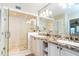 Modern bathroom featuring double sinks, granite countertops, and a glass-enclosed shower for a luxurious feel at 7536 Palm Island S Dr # 1522, Placida, FL 33946