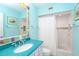 Charming bathroom featuring a colorful vanity and tiled shower/bath, complemented by unique, decorative artwork at 7536 Palm Island S Dr # 1522, Placida, FL 33946