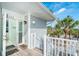 Inviting entrance with light gray siding, white trim, and view of the ocean and tropical trees at 7536 Palm Island S Dr # 1522, Placida, FL 33946