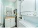 Efficient laundry room featuring a stacked washer and dryer, cabinetry, and a window with shutters at 7536 Palm Island S Dr # 1522, Placida, FL 33946