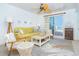 Inviting living room with coastal-themed decor, a ceiling fan, and sliding glass doors leading to an outdoor view at 7536 Palm Island S Dr # 1522, Placida, FL 33946
