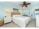 Charming main bedroom with coastal decor, ceiling fan and outdoor access to balcony at 7536 Palm Island S Dr # 1522, Placida, FL 33946