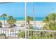 Relaxing screened-in porch offering scenic views of the swimming pool and palm trees at 7536 Palm Island S Dr # 1522, Placida, FL 33946