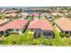 Aerial view highlights a well-kept home with a screened-in lanai and lush landscaping in a quiet neighborhood at 7620 Raptor Ct, North Port, FL 34287