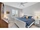 Cozy bedroom with a white bed, blue patterned bedding, and natural light through a window with white shutters at 7620 Raptor Ct, North Port, FL 34287