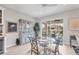 Bright dining area with a glass table and chairs, view into screened lanai, plus built in display case at 7620 Raptor Ct, North Port, FL 34287