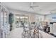 Cozy dining area with a glass table, stylish chairs, large windows, and seamless transition to living room at 7620 Raptor Ct, North Port, FL 34287