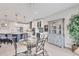 Dining area featuring glass table and seating, flowing into the kitchen, with ample counter space and modern appliances at 7620 Raptor Ct, North Port, FL 34287