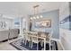 Dining area with decorative lighting, an ocean-themed painting, and view into living room at 7620 Raptor Ct, North Port, FL 34287