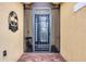 Inviting front entrance featuring a secure screen door with decorative palm design and brick entryway at 7620 Raptor Ct, North Port, FL 34287