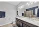 Main bathroom with double sink vanity, granite countertop, a large mirror, and separate tub and shower at 7620 Raptor Ct, North Port, FL 34287