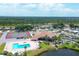 Aerial view showcasing the community amenities, pool, tennis court, and landscaping at 809 Tangerine Woods Blvd # 215, Englewood, FL 34223