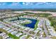Panoramic aerial view of the community showcasing the homes surrounding a beautiful blue lake at 809 Tangerine Woods Blvd # 215, Englewood, FL 34223