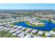 Stunning aerial view of the neighborhood's lake, residential houses, trees, and landscaping at 809 Tangerine Woods Blvd # 215, Englewood, FL 34223