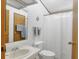 Bright bathroom with a shower, toilet, and mirror over a classic sink at 809 Tangerine Woods Blvd # 215, Englewood, FL 34223