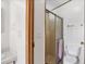 Bathroom with tiled flooring, toilet and walk-in shower with glass doors at 809 Tangerine Woods Blvd # 215, Englewood, FL 34223