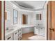 Bright bathroom featuring dual sinks, makeup counter, and plenty of storage space at 809 Tangerine Woods Blvd # 215, Englewood, FL 34223