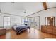 Bedroom with natural light, wood-look floors, and plenty of dresser storage at 809 Tangerine Woods Blvd # 215, Englewood, FL 34223