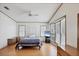 Bedroom with natural light, wood-look floors, and built in display shelves at 809 Tangerine Woods Blvd # 215, Englewood, FL 34223