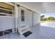 Comfortable front entry beneath the carport provides shade with convenient step access to the home at 809 Tangerine Woods Blvd # 215, Englewood, FL 34223