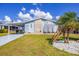Charming single-story home with a covered carport, well-maintained lawn, and beautiful palm trees at 809 Tangerine Woods Blvd # 215, Englewood, FL 34223