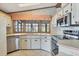 Well-lit kitchen with neutral countertops and stainless steel appliances overlooking the lanai at 809 Tangerine Woods Blvd # 215, Englewood, FL 34223