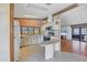 Cozy kitchen with white cabinetry, breakfast bar, and stainless steel appliances, open to the main living space at 809 Tangerine Woods Blvd # 215, Englewood, FL 34223