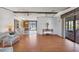 Open-concept living room with wood floors, neutral walls, and an open view to the kitchen and lanai at 809 Tangerine Woods Blvd # 215, Englewood, FL 34223