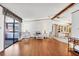 Bright living room featuring wood floors, neutral walls, and a sliding glass door to a screened porch at 809 Tangerine Woods Blvd # 215, Englewood, FL 34223