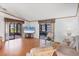 Inviting living room features hardwood floors, large TV, and ample seating with natural lighting at 809 Tangerine Woods Blvd # 215, Englewood, FL 34223
