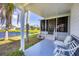 Lovely patio with seating provides a tranquil space to enjoy the lake view with beautiful landscaping at 809 Tangerine Woods Blvd # 215, Englewood, FL 34223