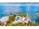 Beautiful aerial view of a community pool overlooking a large blue bay at 11000 Placida Rd # 2702, Placida, FL 33946