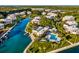 Aerial view of waterfront community with lush landscaping, boat docks, and community pool at 11000 Placida Rd # 2702, Placida, FL 33946