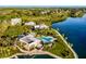 Beautiful aerial of a community pool and waterway showcasing luxurious waterfront homes at 11000 Placida Rd # 2702, Placida, FL 33946