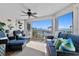 Relaxing sunroom with comfortable seating and a ceiling fan, showcasing stunning waterfront views at 11000 Placida Rd # 2702, Placida, FL 33946