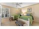 Charming bedroom with two twin beds, soft colors, shuttered window and stylish striped stools at 11000 Placida Rd # 2702, Placida, FL 33946