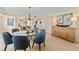 Stylish dining area with a glass table, comfortable seating, and attractive artwork at 11000 Placida Rd # 2702, Placida, FL 33946
