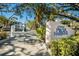 Community entrance with 'Placida Harbour' signage, mature trees, and private gate at 11000 Placida Rd # 2702, Placida, FL 33946