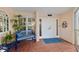 Charming condo entrance with stylish decor, a seating area, and a secure front door at 11000 Placida Rd # 2702, Placida, FL 33946