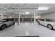 Spacious garage with painted floor, multiple parking spaces, and bright lighting at 11000 Placida Rd # 2702, Placida, FL 33946